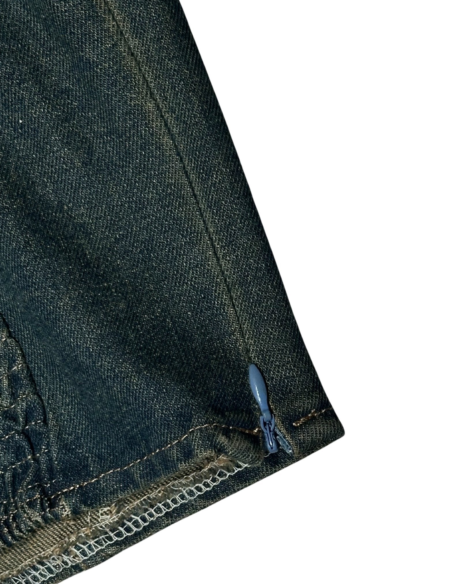 Close-up of dark blue denim fabric with a zipper on a white background