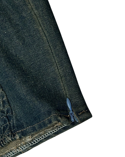 Close-up of dark blue denim fabric with a zipper on a white background
