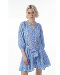 Woman wearing a blue patterned dress on a white background