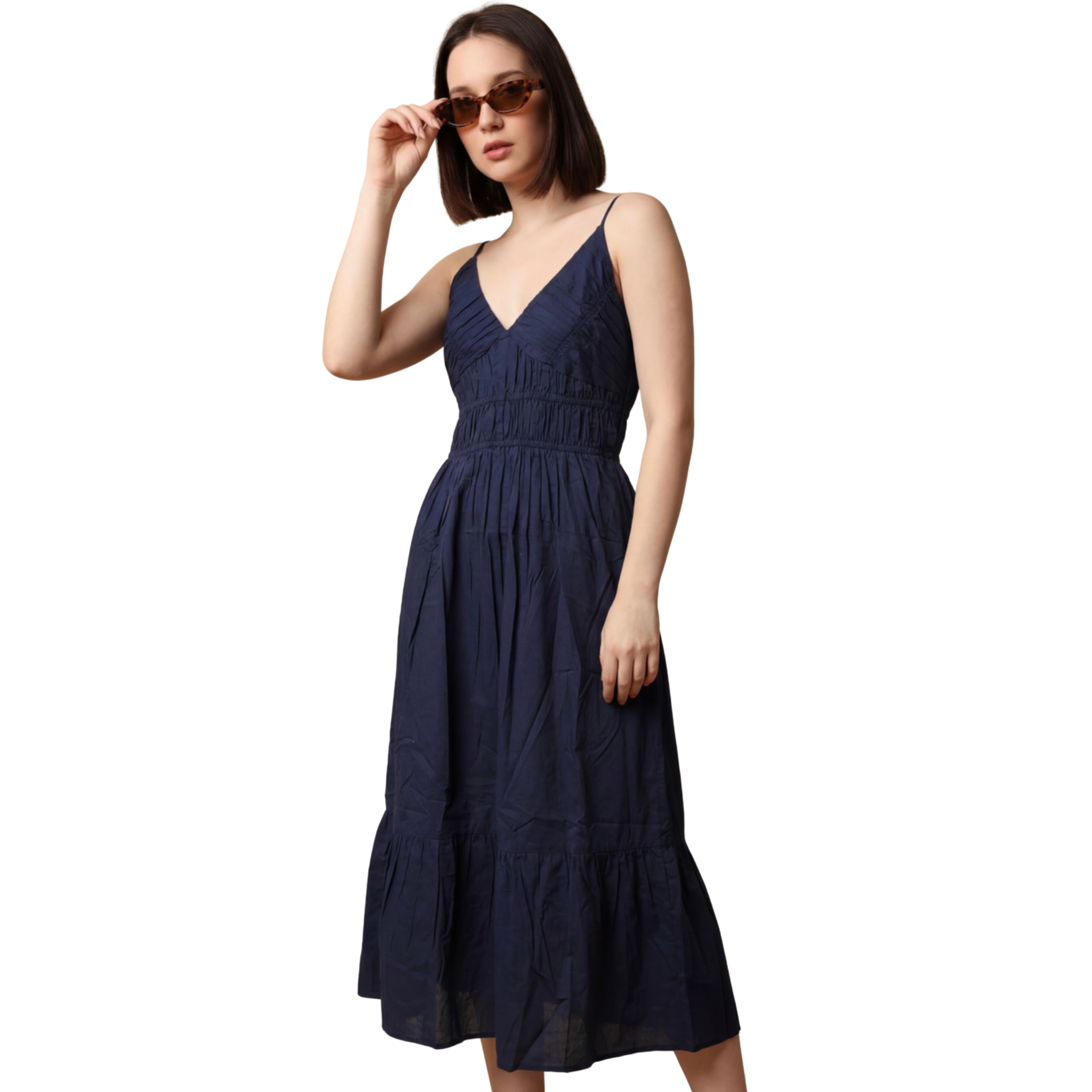 Woman wearing a navy blue dress on a white background