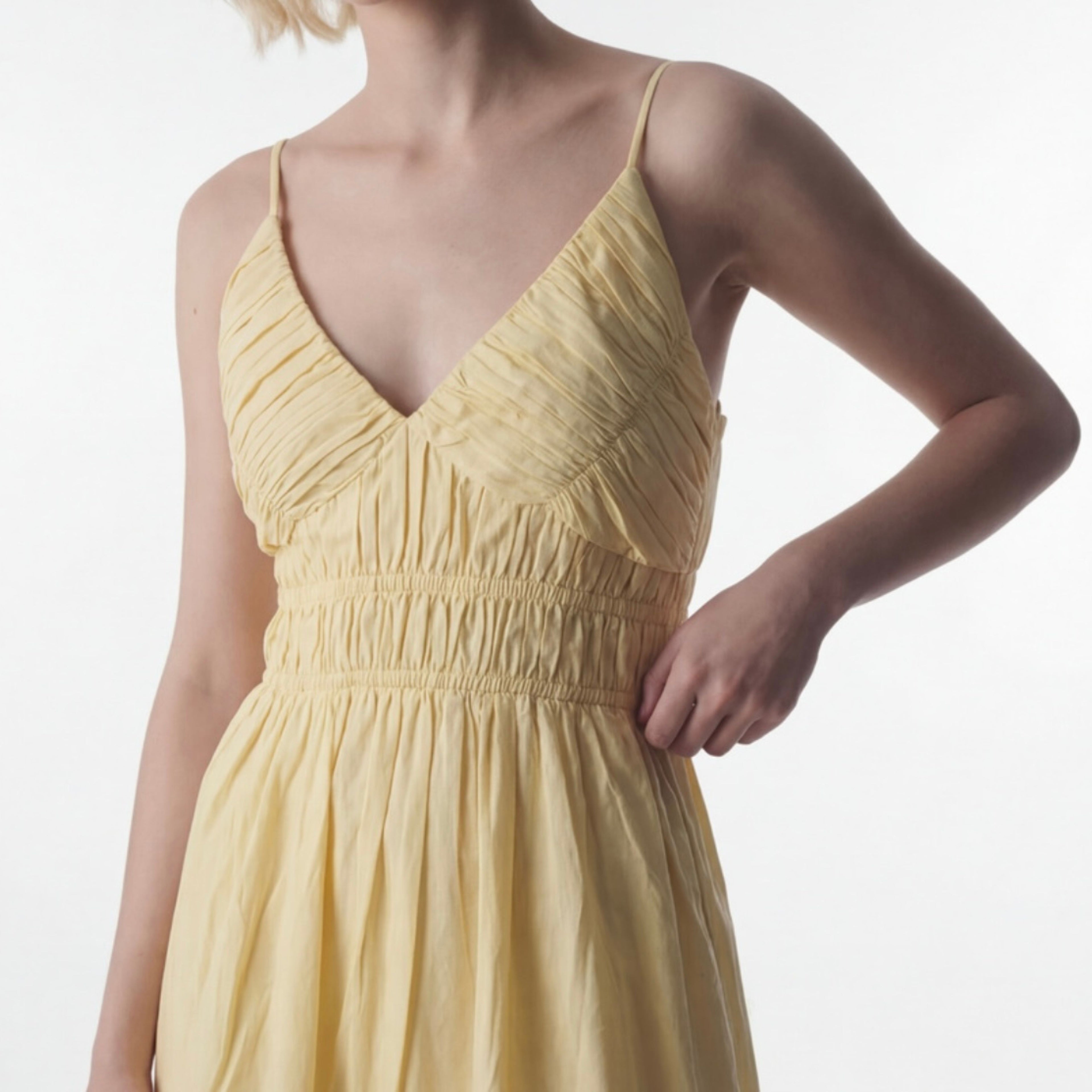 Yellow dress worn by a person on a white background