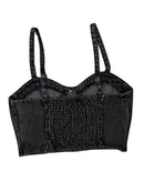 Black denim crop top with suspenders on a white background